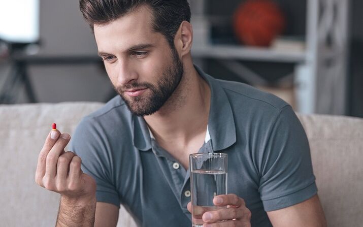 a man drinks a pill to enlarge the glans