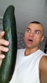 Man with a giant cucumber